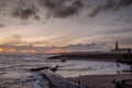 Sunrise at a chilly Cullercoats Bay in the north east of England, with Tynemouth Pier and the lighthouse in the distance Royalty Free Stock Photo