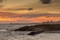 Sunrise at a chilly Cullercoats Bay in the north east of England, with Tynemouth Pier and the lighthouse in the distance Royalty Free Stock Photo