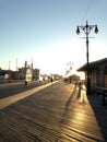 Sunrise on Coney Island Beach and Boardwalk. Royalty Free Stock Photo