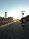 Sunrise on Coney Island Boardwalk. Royalty Free Stock Photo