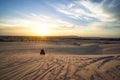 Sunrise in desert. Scene with two ATV bikers. Tourists ride on an off-road ATV through the sand dunes of the Vietnamese Royalty Free Stock Photo