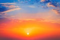 Sunrise dramatic blue sky with orange sun rays breaking through the clouds. Nature background Royalty Free Stock Photo
