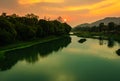 Sunrise dramatic sky at dawn with leading river water flow and forest trails Royalty Free Stock Photo