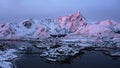 Sunrise drone video of typical norwegian fishing village in Lofoten islands in winter which are very famous for its touristic attr