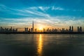 Sunrise in Dubai, dawn over Burj Khalifa. Morning in Dubai, Sun over buildings. Solar path on sea comes from Burj