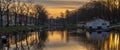 Sunrise in the dutch city of Breda, view of the canal with the boats and the lighthouse