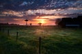 Sunrise on Dutch farm in fog Royalty Free Stock Photo