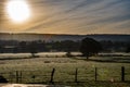 Sunrise and early morning mist over fields Beautiful countryside view Royalty Free Stock Photo