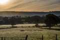 Sunrise and early morning mist over fields Beautiful countryside view Royalty Free Stock Photo