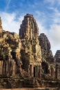 Sunrise on a face tower in the Bayon temple in Angkor Thom, Angkor. Cambodia. Vertical view Royalty Free Stock Photo