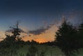 Sunrise on the farm with trees in silhouette Royalty Free Stock Photo