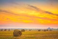 Sunrise field, hay bale in Belarus. Royalty Free Stock Photo