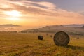 Beautiful Sunrise on a Farm Field with Round Hay Bales