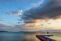 Sunrise with fluffy clouds on a golden blue sky over calm sea wi Royalty Free Stock Photo