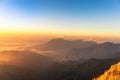 Sunrise with fog covered layers mountain hills in early morning from view point of Phu Chi Dao or Phu Chee Dao mountain at Chiang Royalty Free Stock Photo