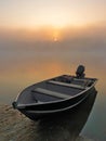 Sunrise and fog on the lake boat on the shore - morning fog - morning haze - boat on the lake sunrise - mist on the water Royalty Free Stock Photo