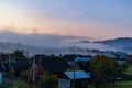 Sunrise on a foggy morning in a small mountain village. Royalty Free Stock Photo