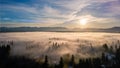 Sunrise on a foggy suburb town from a drone