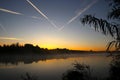 Sunrise at the forest lake with steaming water