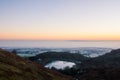 Sunrise on a frosty, misty winters morning. Looking at a reservoir across the English countryside. Malvern Hills. UK.