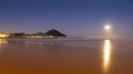 Sunrise with full moon over the Zurriola beach, city of Donostia-San Sebastian, Basque Country Royalty Free Stock Photo