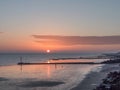 Sunrise Globe at low tide. Royalty Free Stock Photo