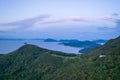 Sunrise glow in sky over forested mountain on Shodo Island in Seto Inland Sea Royalty Free Stock Photo