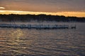 Sunrise Over a Lake with Docks in the Mist Rising Above the Water Royalty Free Stock Photo