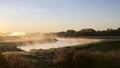 Sunrise in the golf club with mist and birds Royalty Free Stock Photo