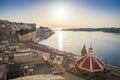 Sunrise at the Grand Harbour of Malta with the ancient walls of Valletta