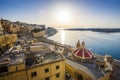 Sunrise at the Grand Harbour of Malta with the ancient walls of Valletta Royalty Free Stock Photo