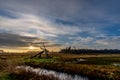 Sunrise in a grass landscape with a old windmill in front in the Netherlands Royalty Free Stock Photo