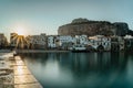 Sunrise in harbor of Cefalu, Sicily, Italy, old town panoramic view with colorful waterfront houses, sea and La Rocca cliff. Royalty Free Stock Photo