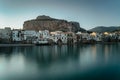 Sunrise in harbor of Cefalu, Sicily, Italy, old town panoramic view with colorful waterfront houses, sea and La Rocca cliff. Royalty Free Stock Photo