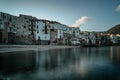 Sunrise in harbor of Cefalu, Sicily, Italy, old town panoramic view with colorful waterfront houses, sea and La Rocca cliff. Royalty Free Stock Photo