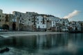 Sunrise in harbor of Cefalu, Sicily, Italy, old town panoramic view with colorful waterfront houses, sea and La Rocca cliff. Royalty Free Stock Photo