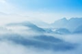 Sunrise on high angle view with white fog in early morning over rainforest mountain in thailand