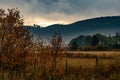 Sunrise on the hills, on a foggy fall morning, with red, gold and orange leaves. Royalty Free Stock Photo