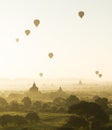 Sunrise and hot air balloons fly over misty Bagan, Myanmar Royalty Free Stock Photo