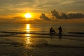 Sunrise idyllic with fisherman at the beach Royalty Free Stock Photo