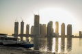 Sunrise in Jadaf area of Dubai, view of Dubai creek Harbor construction of which is partially completed. Old abandoned ships can