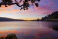 Sunrise landscape. Lake surrounded by mountains and hills. Colorful sky. Amazing water reflection. Nature background. Foreground Royalty Free Stock Photo