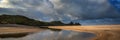 Sunrise landscape panorama Three Cliffs Bay in Wales with dramatic sky Royalty Free Stock Photo