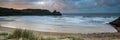 Sunrise landscape panorama Three Cliffs Bay in Wales with dramatic sky Royalty Free Stock Photo