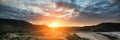 Sunrise landscape panorama Three Cliffs Bay in Wales with dramatic sky Royalty Free Stock Photo