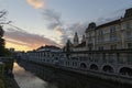 Sunrise landscape view of ancient city center of Ljubljana. Embankment of Ljubljanica River with colorful houses Royalty Free Stock Photo