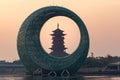 Sunrise landscapes with a Chinese traditional pagoda and moon like architecture building on lake, in Xinglin Bay, Xiamen, China