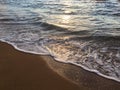 Sunrise Light on Pacific Ocean Waves on Beach in Kapaa on Kauai Island in Hawaii. Royalty Free Stock Photo