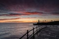 Sunrise and a lighthouse in Mevagissey harbour, Cornwall