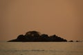 Sunrise at Malawi lake with small islet and fishermans